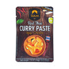 Packaging of SIAM Red Thai Curry Paste with wooden background and food image.