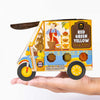 Curry paste packaging shaped like a Tuktuk motorcycle held in a hand